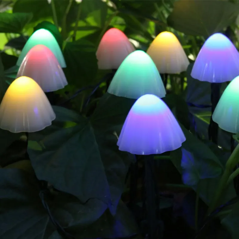 T SUN Lighting solar mushroom lights scattered along a garden path at night